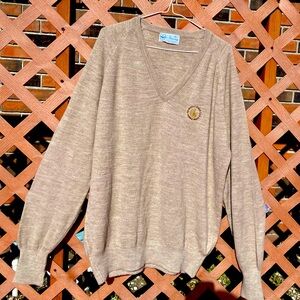 A vintage man’s sweater. The color is oatmeal.